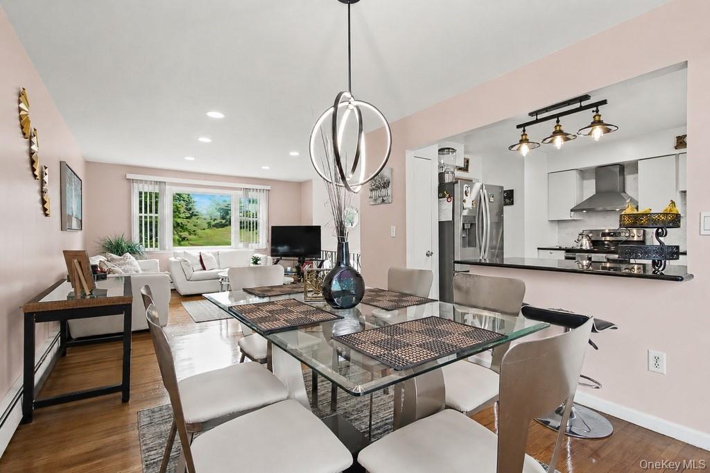 167 Kings Ferry Road Buchanan, NY 10511 - Photo 7 of 26 Open-concept dining area, featuring a modern chandelier, with direct access to deck