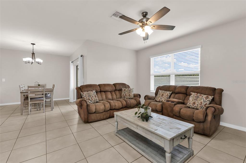 4219 Manatee Lane Punta Gorda, FL 33980 - Photo 13 of 56 a living room with furniture and a chandelier