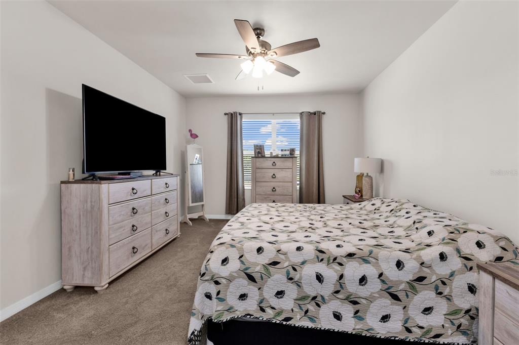 4219 Manatee Lane Punta Gorda, FL 33980 - Photo 18 of 56 a bedroom with a bed and a flat screen tv