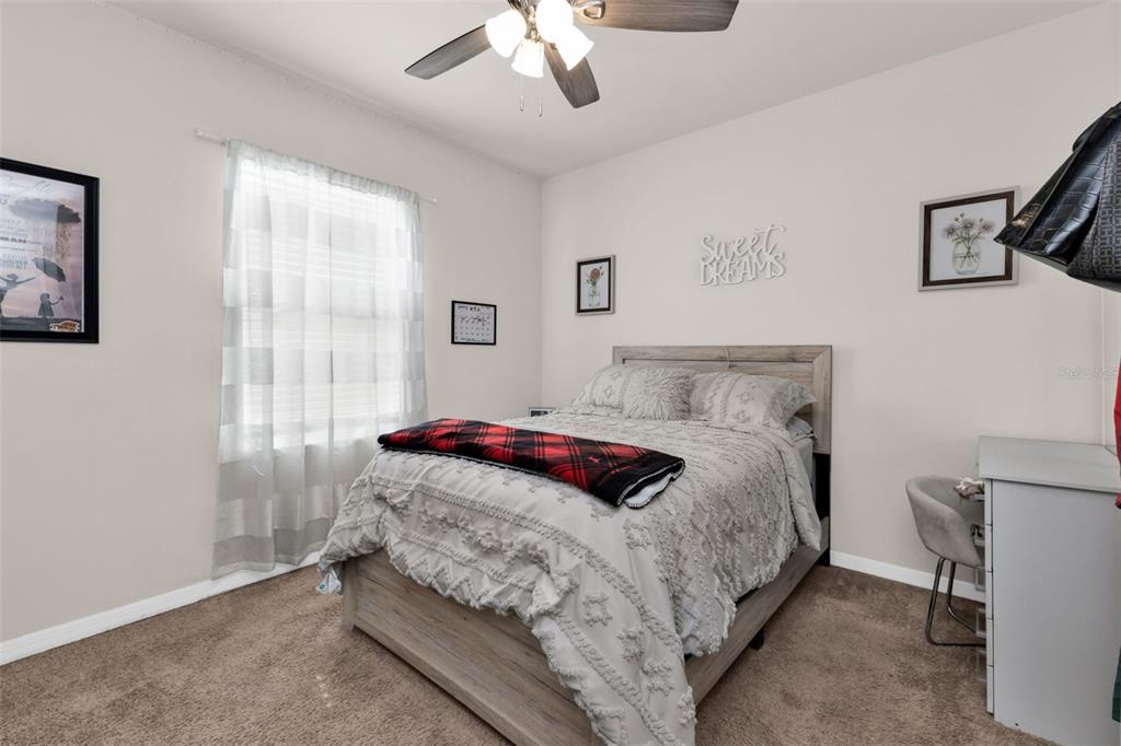 4219 Manatee Lane Punta Gorda, FL 33980 - Photo 26 of 56 a bedroom with a bed and a chandelier