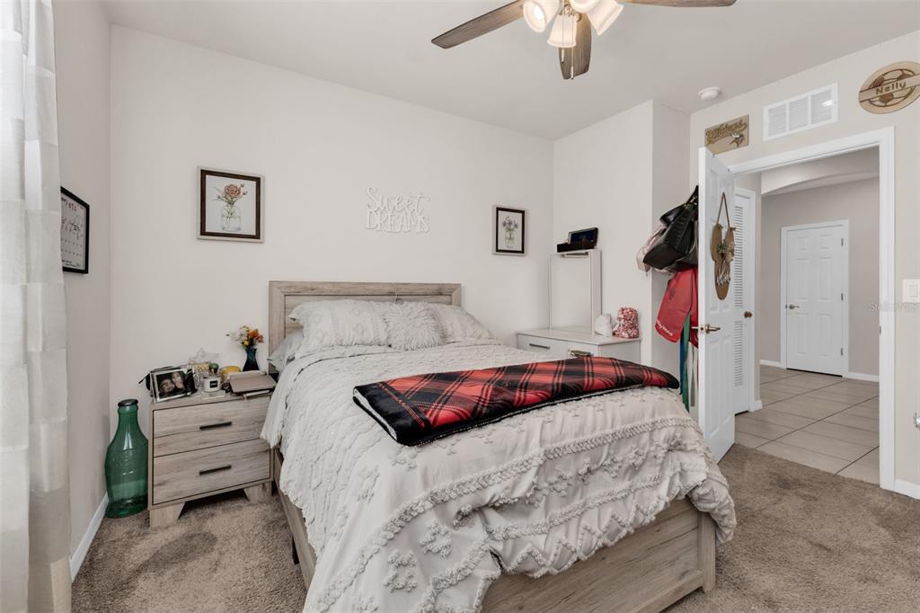 4219 Manatee Lane Punta Gorda, FL 33980 - Photo 27 of 56 a bedroom with a bed and a chandelier