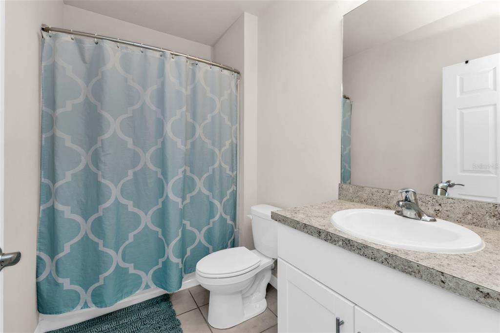 4219 Manatee Lane Punta Gorda, FL 33980 - Photo 27 of 56 a bathroom with a granite countertop sink toilet and a mirror