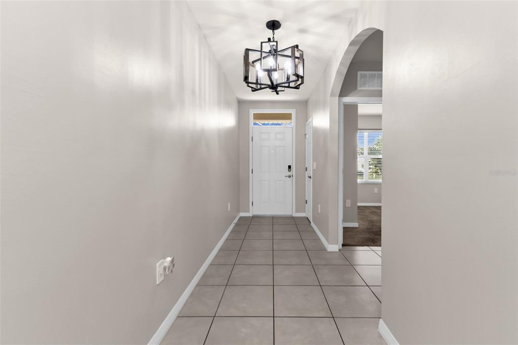 4219 Manatee Lane Punta Gorda, FL 33980 - Photo 6 of 56 a view of a hallway with a chandelier
