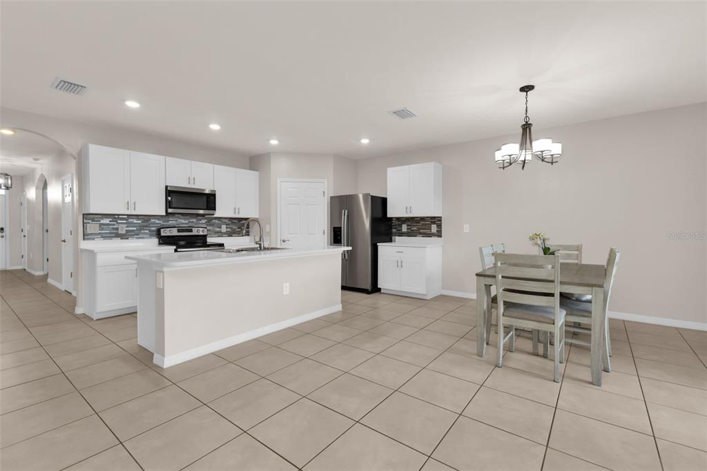 4219 Manatee Lane Punta Gorda, FL 33980 - Photo 10 of 56 a kitchen with granite countertop cabinets and stainless steel appliances