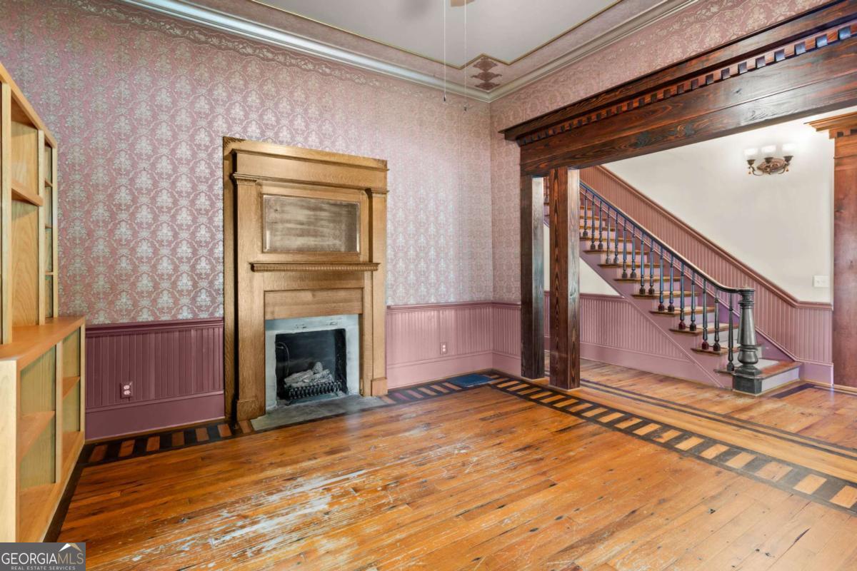 212 Yancey Road Arnoldsville, GA 30619 - Photo 12 of 50 a view of an empty room with wooden floor fireplace and a window