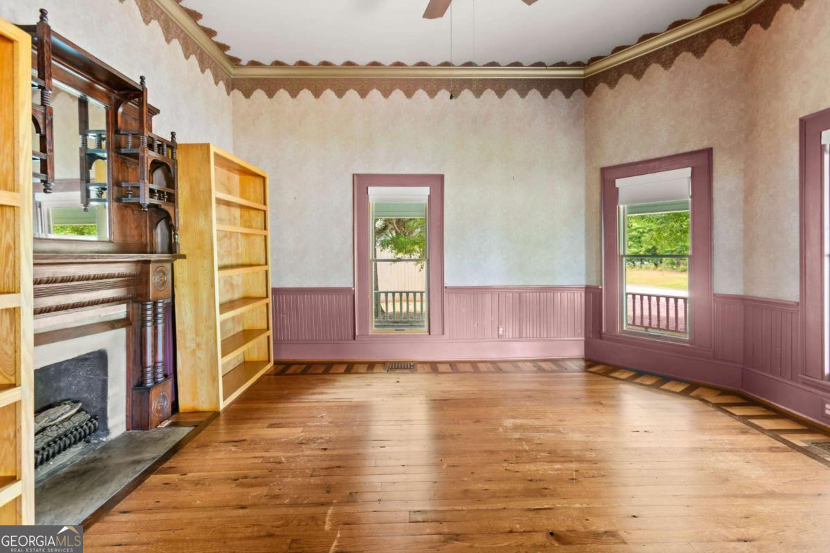 212 Yancey Road Arnoldsville, GA 30619 - Photo 14 of 50 a view of an empty room with a window and wooden floor