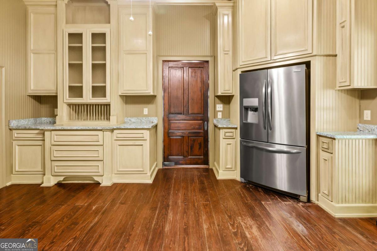 212 Yancey Road Arnoldsville, GA 30619 - Photo 21 of 50 a kitchen with granite countertop wooden floors stainless steel appliances and cabinets