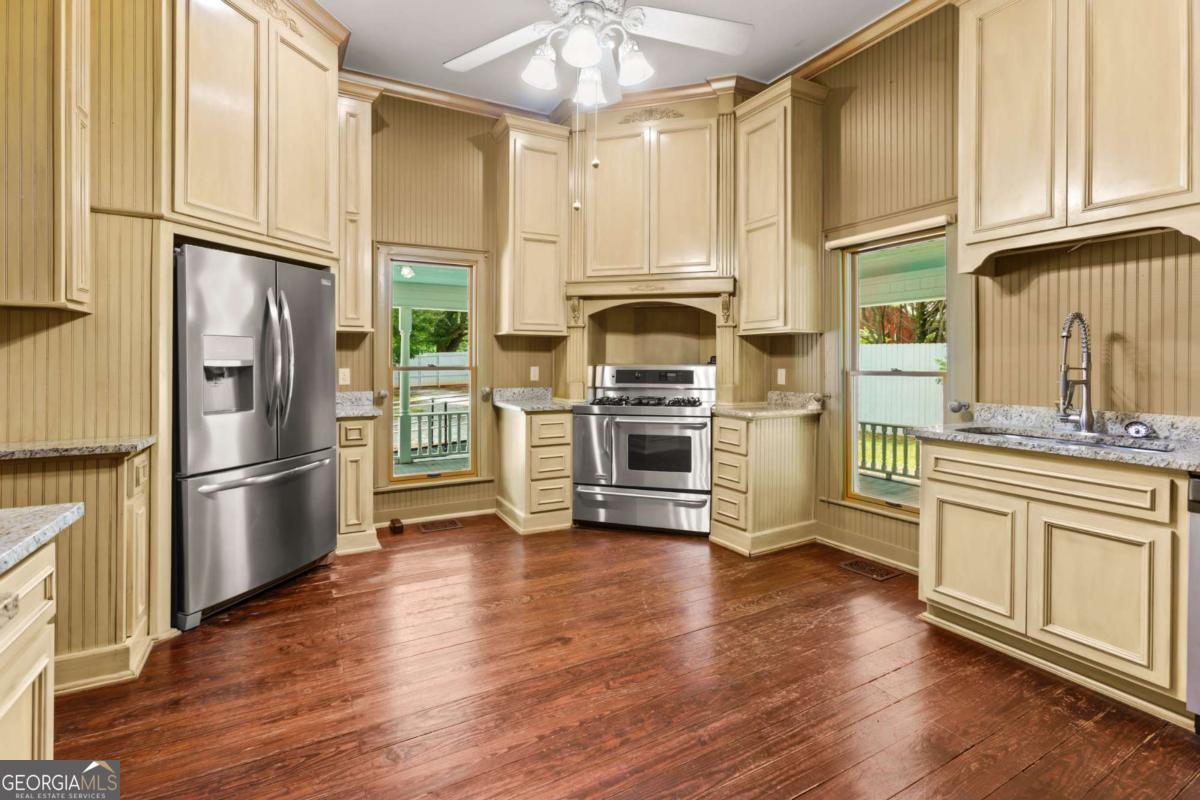212 Yancey Road Arnoldsville, GA 30619 - Photo 22 of 50 a kitchen with stainless steel appliances a refrigerator sink and microwave