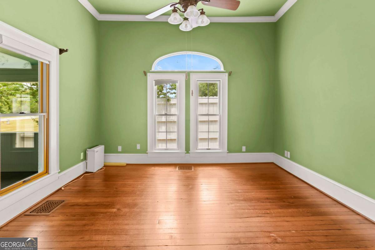 212 Yancey Road Arnoldsville, GA 30619 - Photo 25 of 50 a view of an empty room with a window and wooden floor