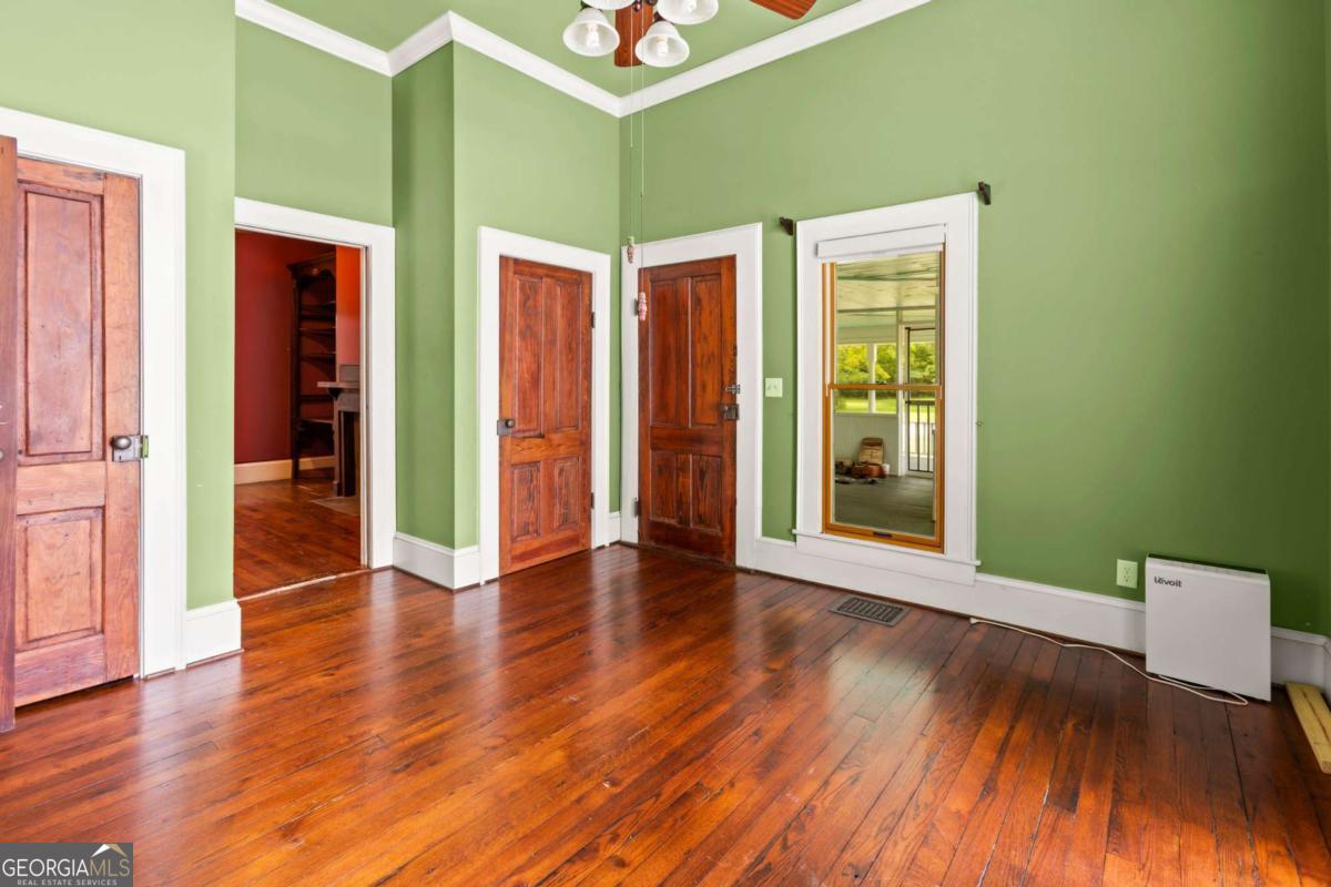 212 Yancey Road Arnoldsville, GA 30619 - Photo 27 of 50 a view of an empty room with wooden floor and a window