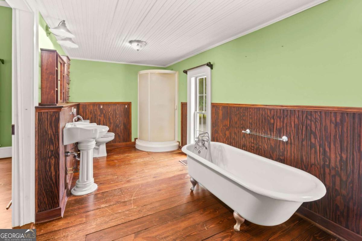 212 Yancey Road Arnoldsville, GA 30619 - Photo 30 of 50 a bathroom with a tub and sink