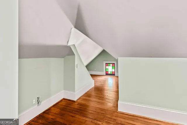 a view of a room with wooden floor and a window
