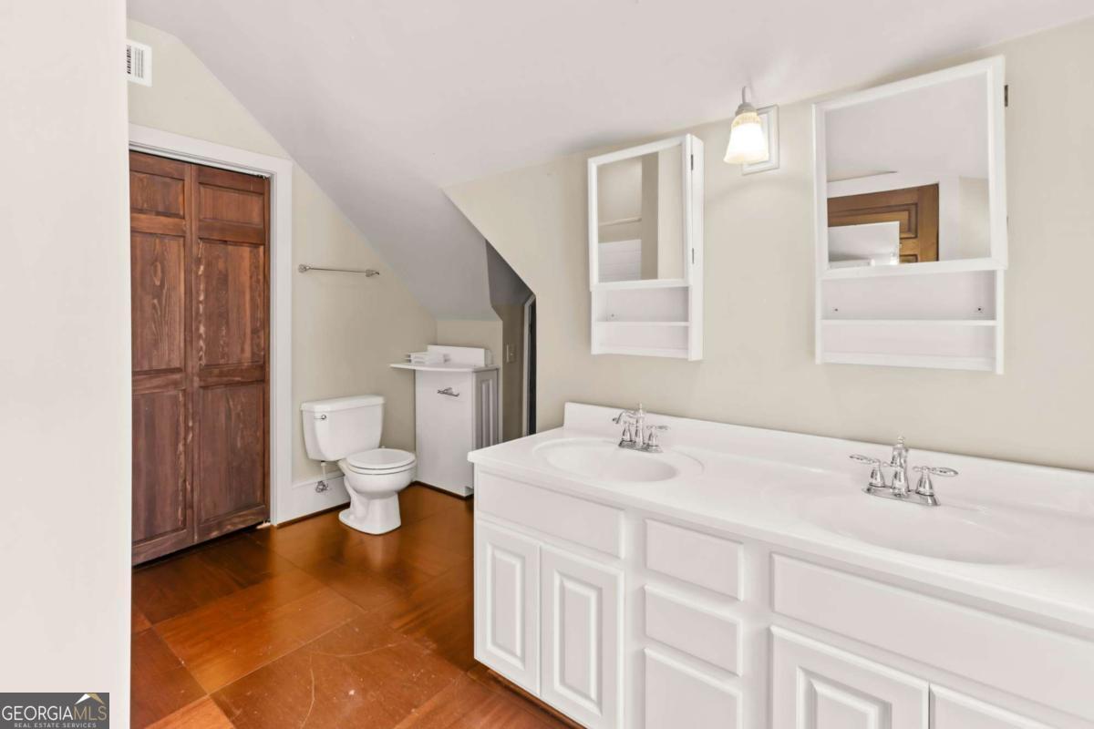 212 Yancey Road Arnoldsville, GA 30619 - Photo 38 of 50 a spacious bathroom with a double vanity sink mirror and toilet