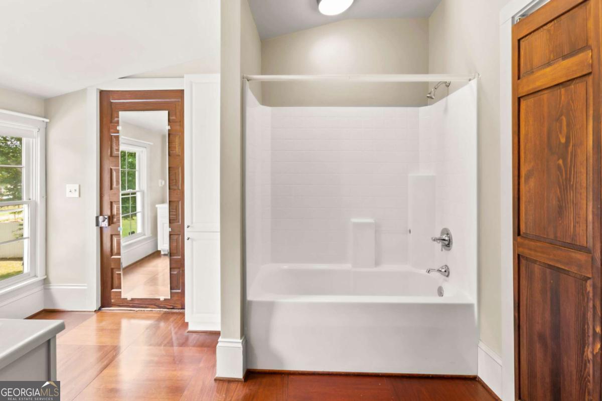 212 Yancey Road Arnoldsville, GA 30619 - Photo 39 of 50 a bathroom with a bathtub and a shower