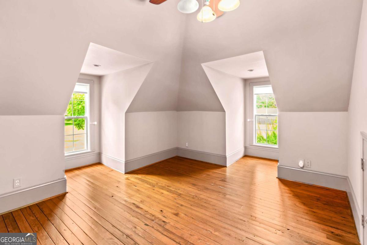 212 Yancey Road Arnoldsville, GA 30619 - Photo 41 of 50 a view of an empty room with wooden floor and a window