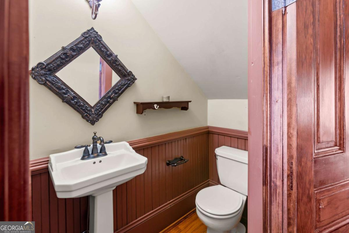 212 Yancey Road Arnoldsville, GA 30619 - Photo 42 of 50 a bathroom with a toilet a sink and a mirror