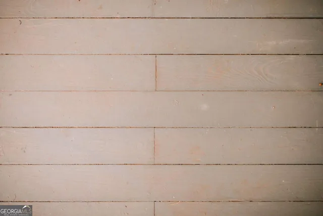 a view of a big room with wooden floor windows and outdoor view