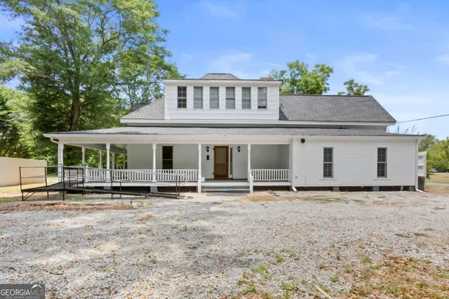 a view of a house with a yard and garage