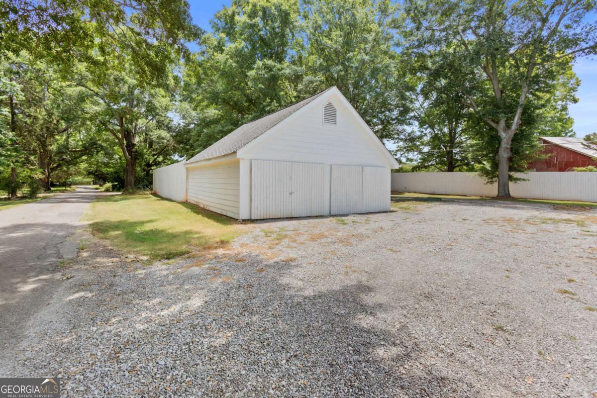 212 Yancey Road Arnoldsville, GA 30619 - Photo 48 of 50 a view of a house with a yard and garage