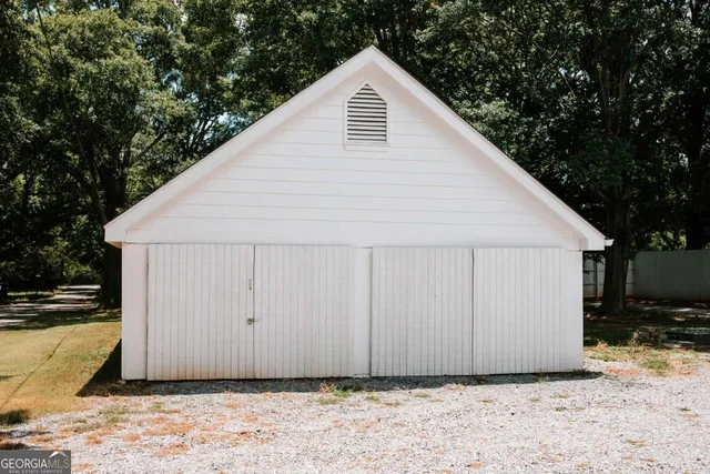 a view of a backyard with large trees