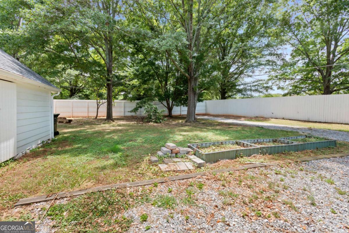212 Yancey Road Arnoldsville, GA 30619 - Photo 50 of 50 a view of a backyard with large trees