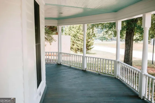 a view of a room with wooden floor and windows