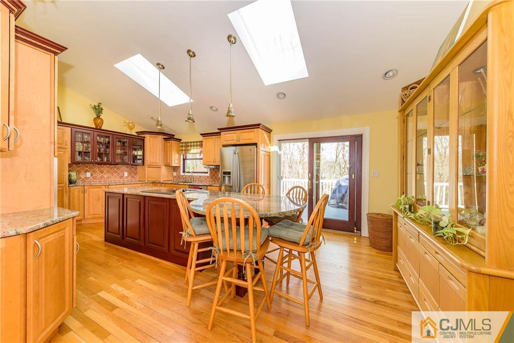 82 Jacobs Road Rockaway, NJ 07866 - Photo 12 of 25 a dining room with stainless steel appliances a dining table and chairs