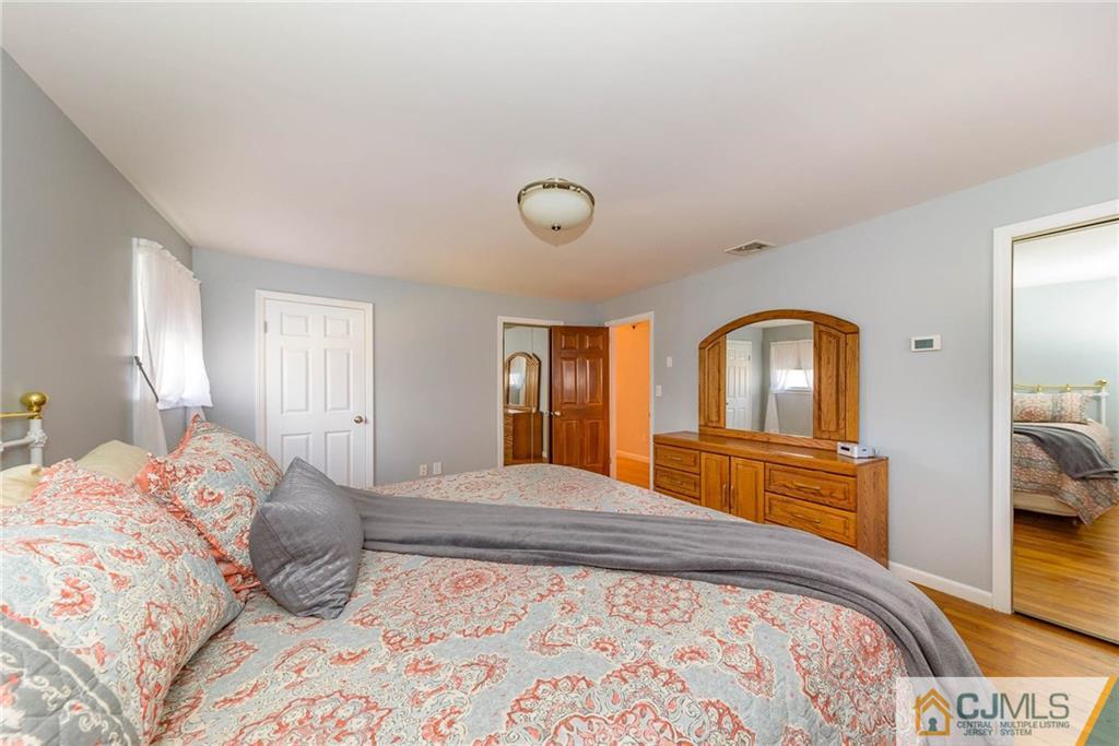 82 Jacobs Road Rockaway, NJ 07866 - Photo 16 of 25 a bedroom with a bed and dresser with mirror