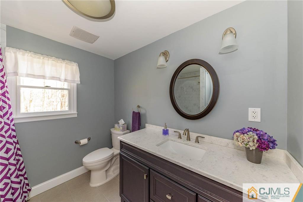 82 Jacobs Road Rockaway, NJ 07866 - Photo 17 of 25 a bathroom with a granite countertop double vanity sink mirror and toilet