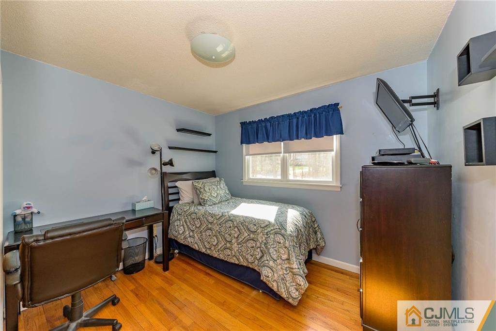 82 Jacobs Road Rockaway, NJ 07866 - Photo 21 of 25 a bedroom with a bed and wooden floor