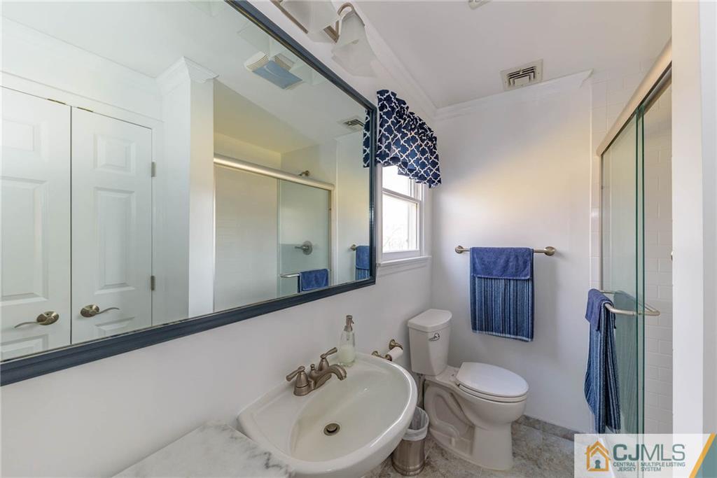 82 Jacobs Road Rockaway, NJ 07866 - Photo 22 of 25 a bathroom with a sink a toilet and shower