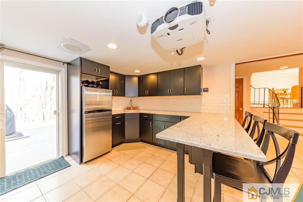 82 Jacobs Road Rockaway, NJ 07866 - Photo 7 of 25 a kitchen with stainless steel appliances kitchen island granite countertop a refrigerator and a sink