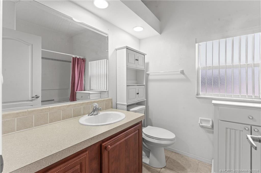 4237 4th Court Lantana, FL 33462 - Photo 27 of 40 a bathroom with a granite countertop sink toilet and shower