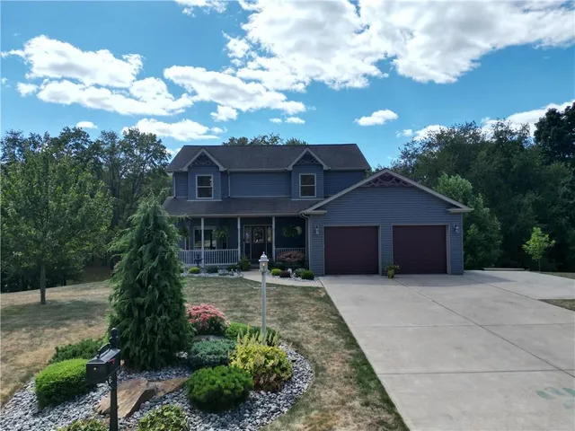 a front view of a house with a garden