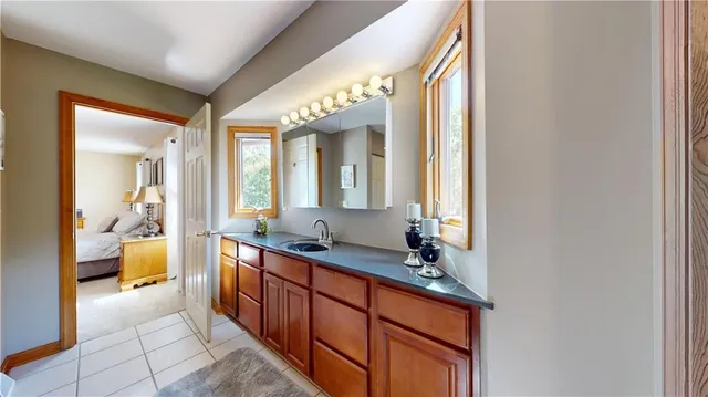 a spacious bathroom with a double vanity sink and a mirror