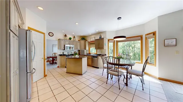 a dining room with furniture and a floor to ceiling window