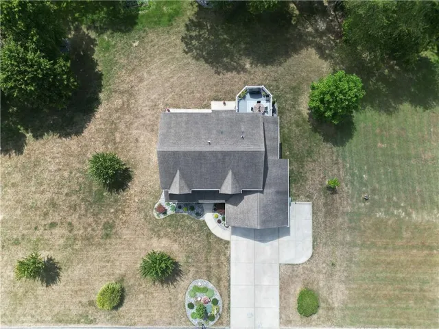 an aerial view of a house with a yard