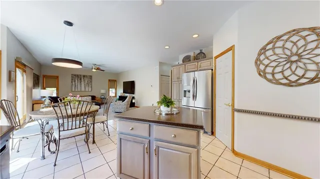 a kitchen with stainless steel appliances a refrigerator and a dining table