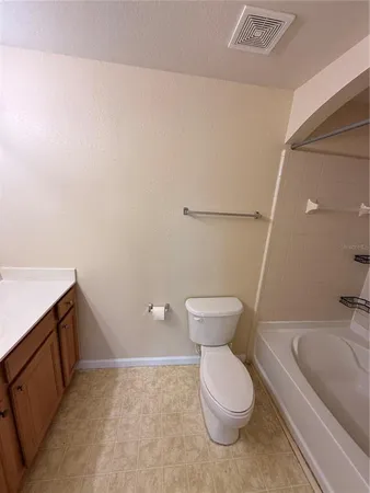 a bathroom with a tub and toilet