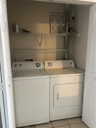an empty room with wooden floor chandelier fan and windows