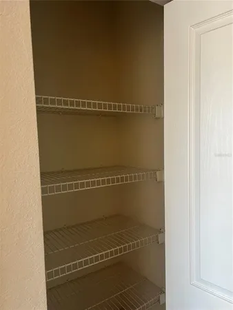 a view of a room with wooden floors and walls