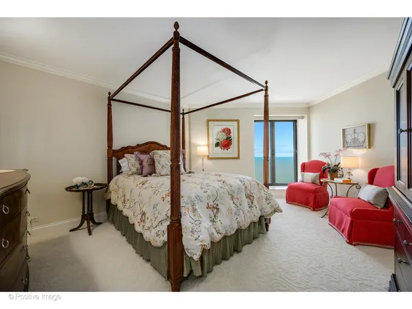 a bedroom with a bed window and couch