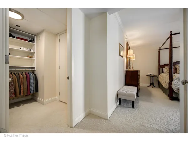 a view of a hallway with couch and a cabinet with wooden floor