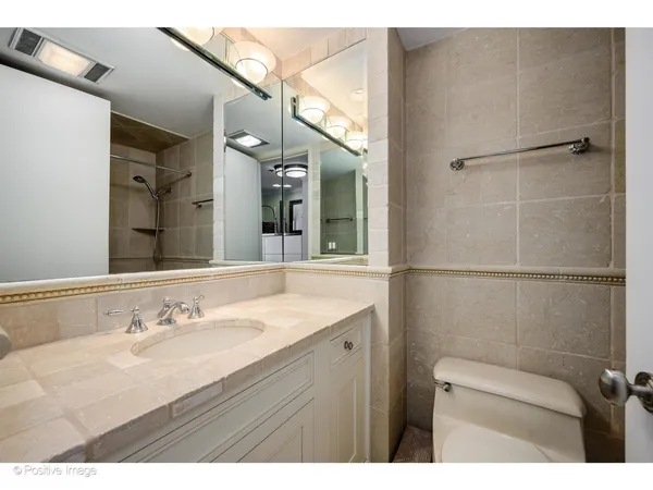a bathroom with a sink vanity granite and a mirror