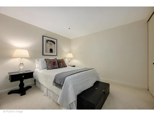 a bedroom with a bed window and wall painting