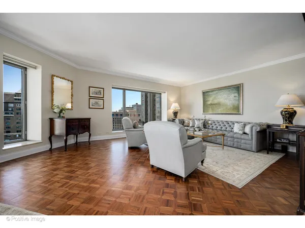 a living room with furniture a dining table and a window