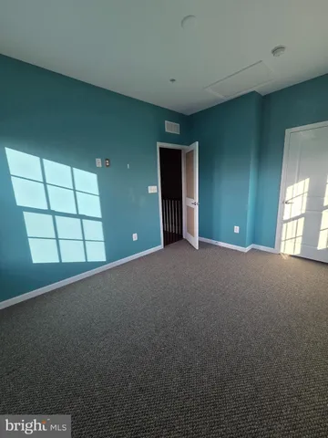 a view of a room that has big windows