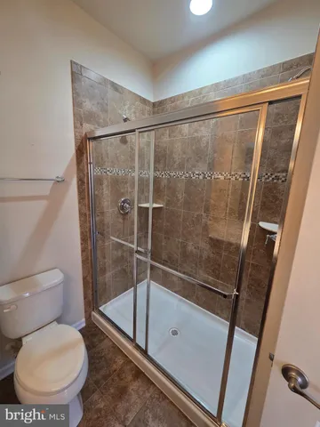 a bathroom with a toilet and a shower