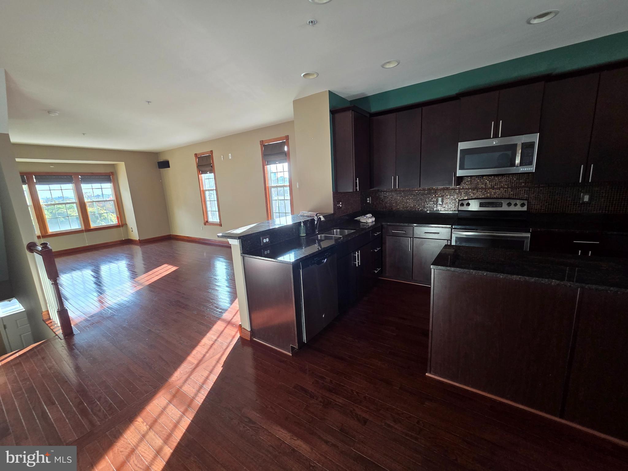 4500 Fait Avenue Baltimore, MD 21224 - Photo 10 of 28 a kitchen with stainless steel appliances wooden floors and wooden cabinets
