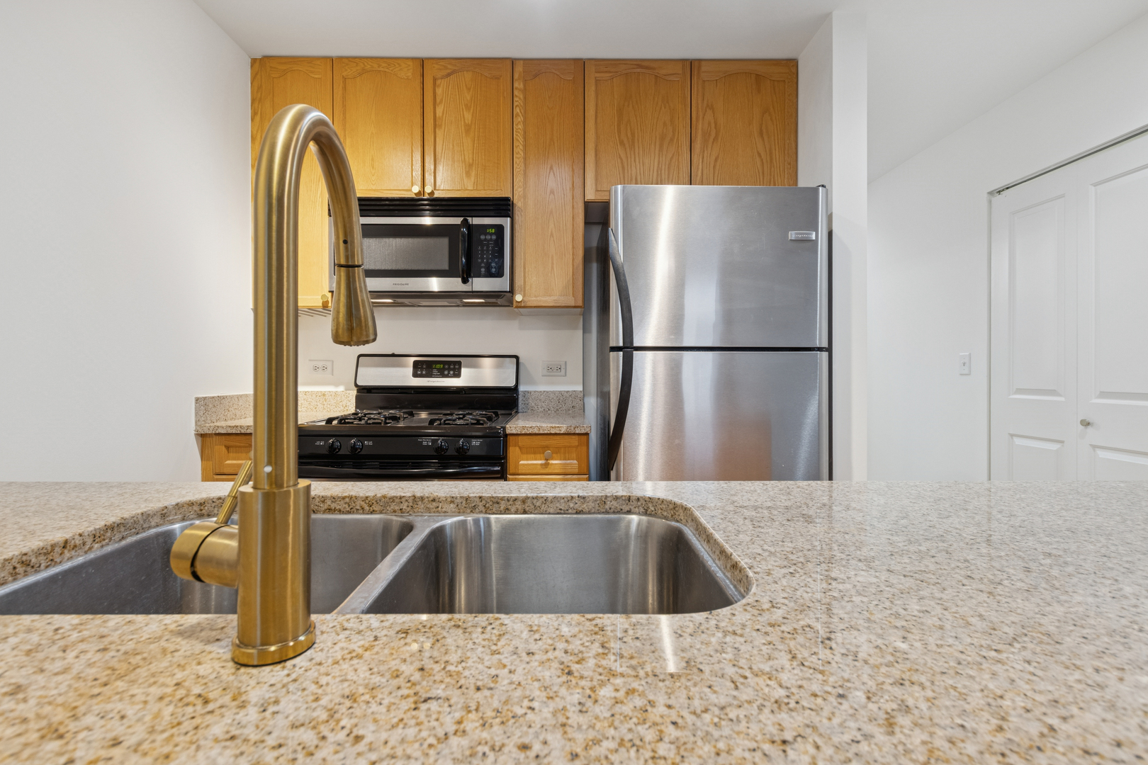1400 South Michigan Avenue, Unit 1708 Chicago, IL 60605 - Photo 6 of 20 a kitchen with a refrigerator sink and stove